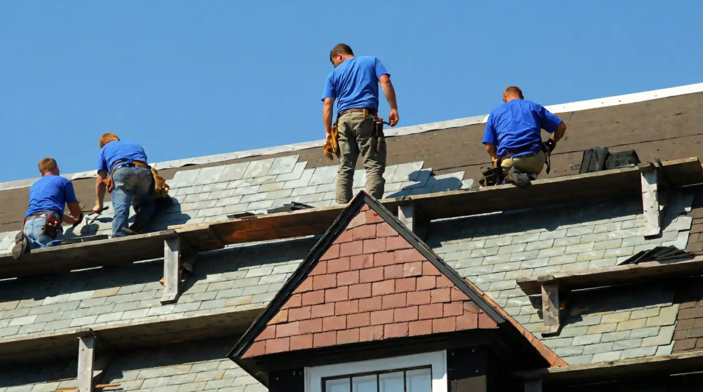 Roof replacement in progress with a team of professional contractors installing new shingles on a residential home in Tacoma, WA