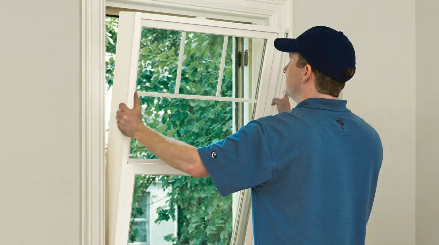Professional contractors performing a residential window insulation and replacement service in Tacoma, WA